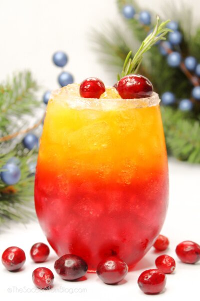 a layered Christmas drink with red and orange colors.