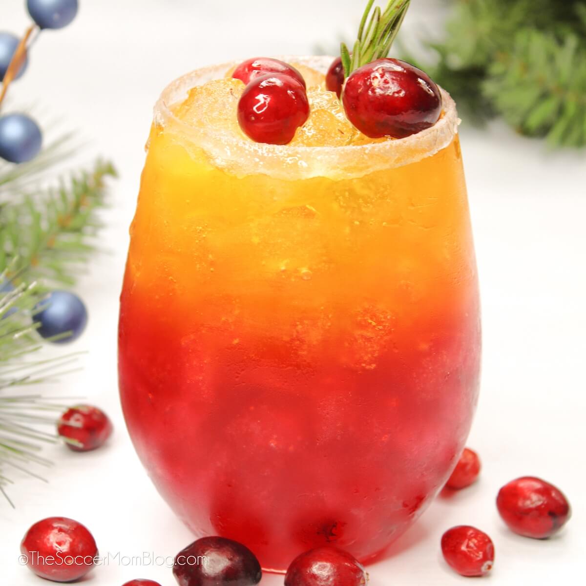 layered red and gold cocktail with cranberries.