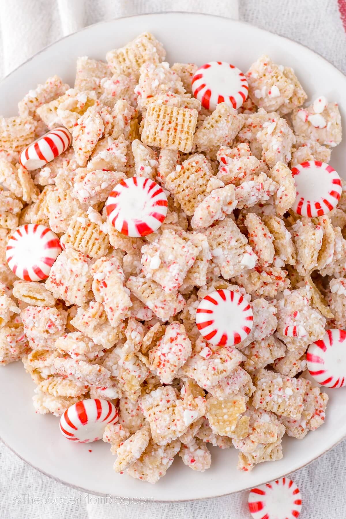 TOP DOWN VIEW OF A BOWL OF CANDY CANE COATED CHEX MIX.