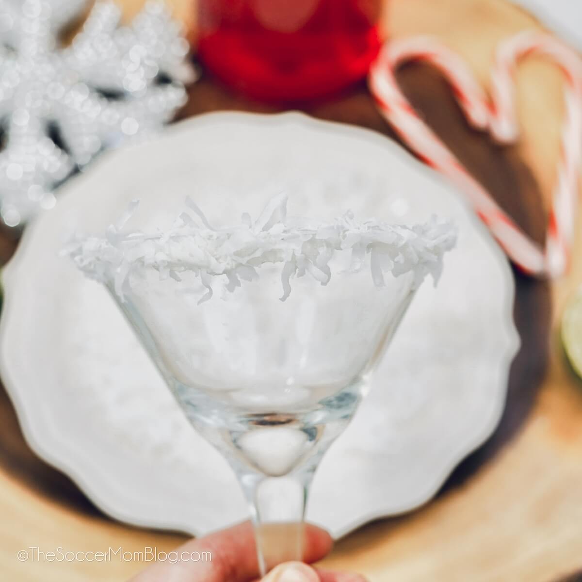 coating the rim of a martini glass with shredded coconut.