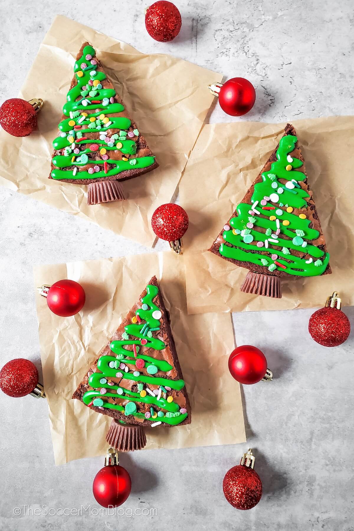 3 brownies shaped and decorated like Christmas trees.
