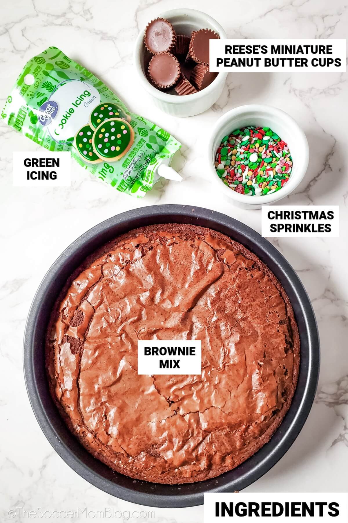 Christmas tree brownies ingredients, with text labels: brownie mix, mini Reese's, green icing, Christmas sprinkles.