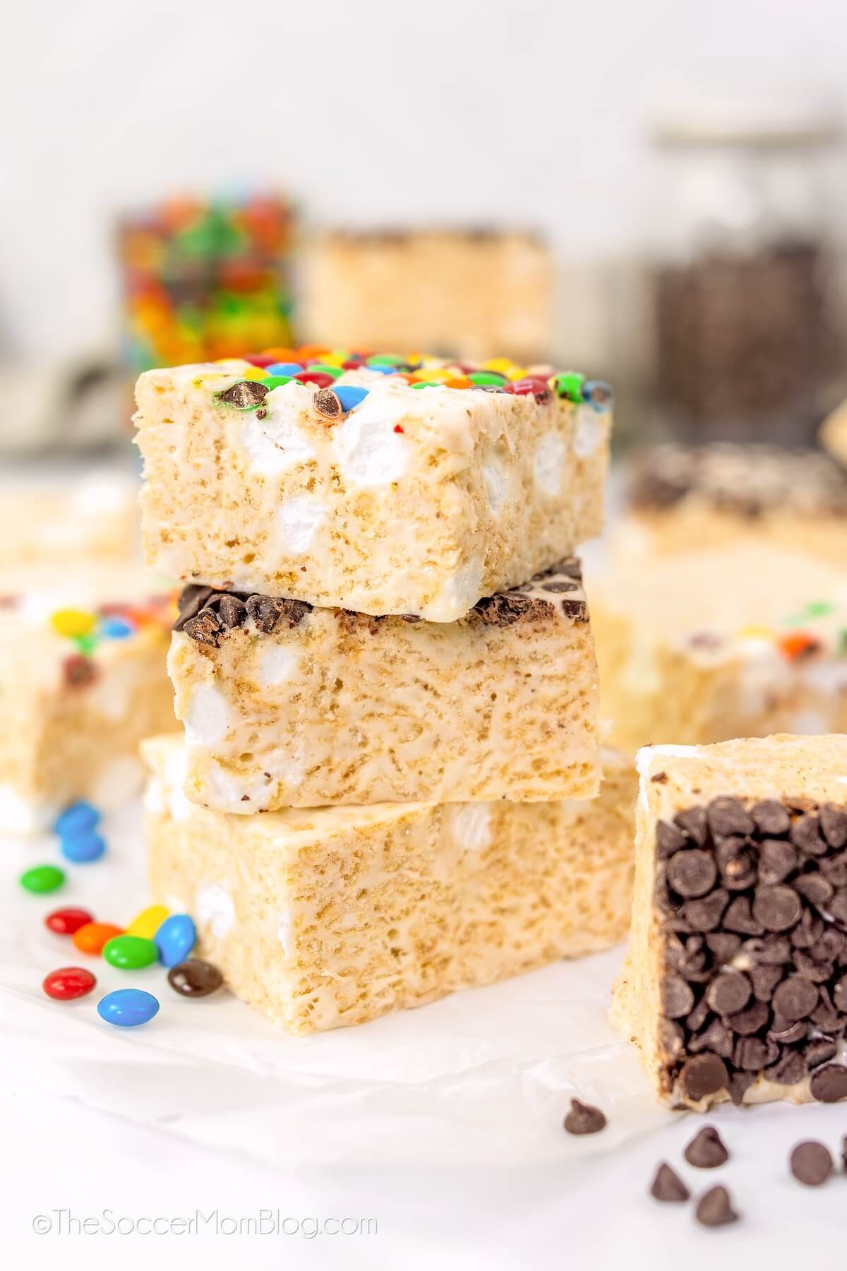 stack of 3 brown butter rice krispie treats squares, with more in background.