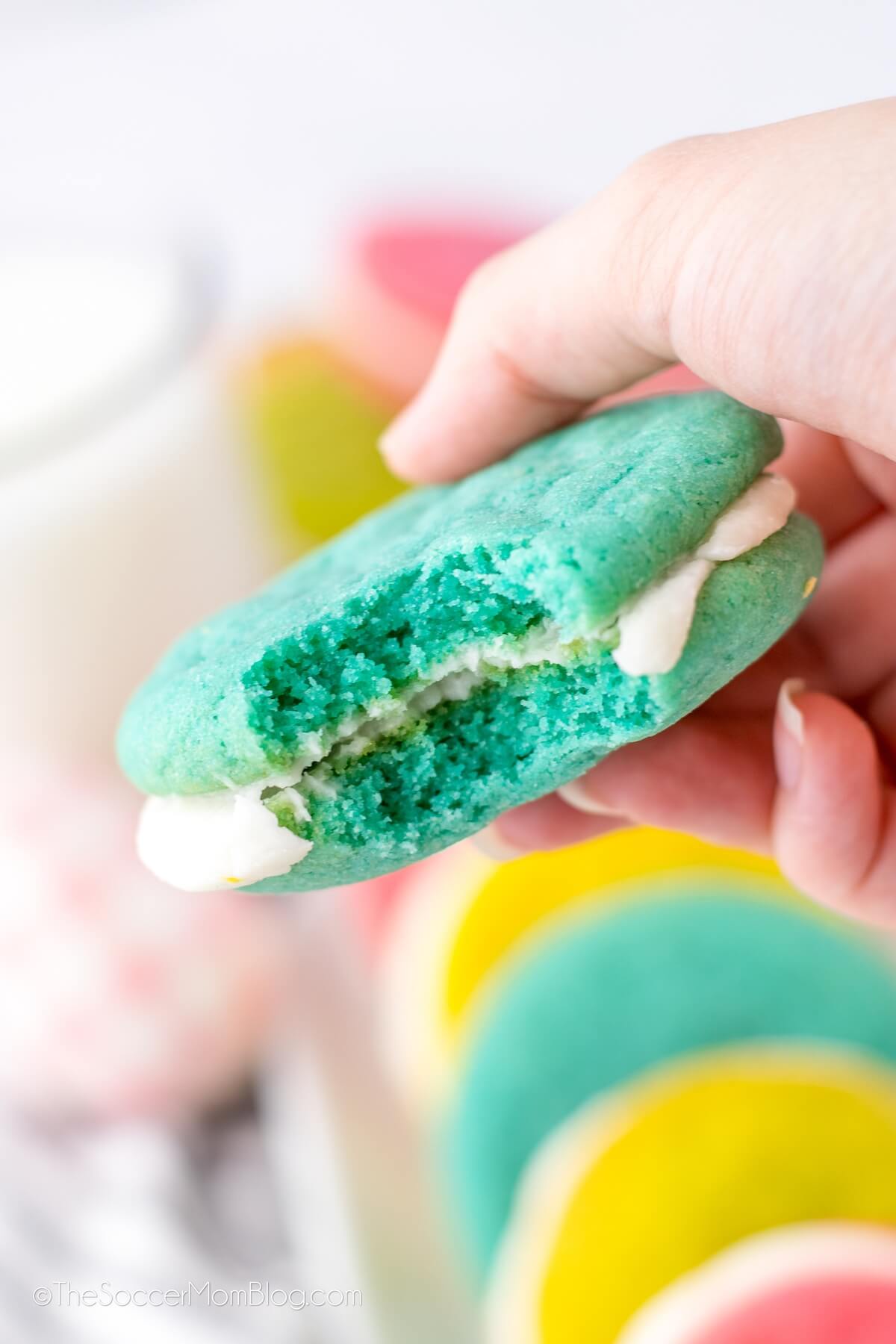 creme-filled blue sandwich cookie with a bite taken.