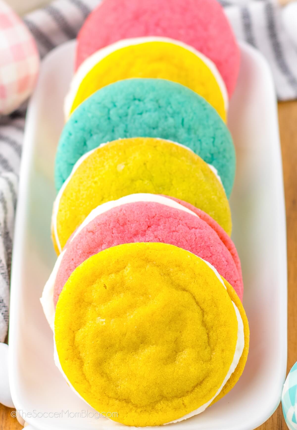 yellow, pink, and blue cream-filled sandwich cookies.