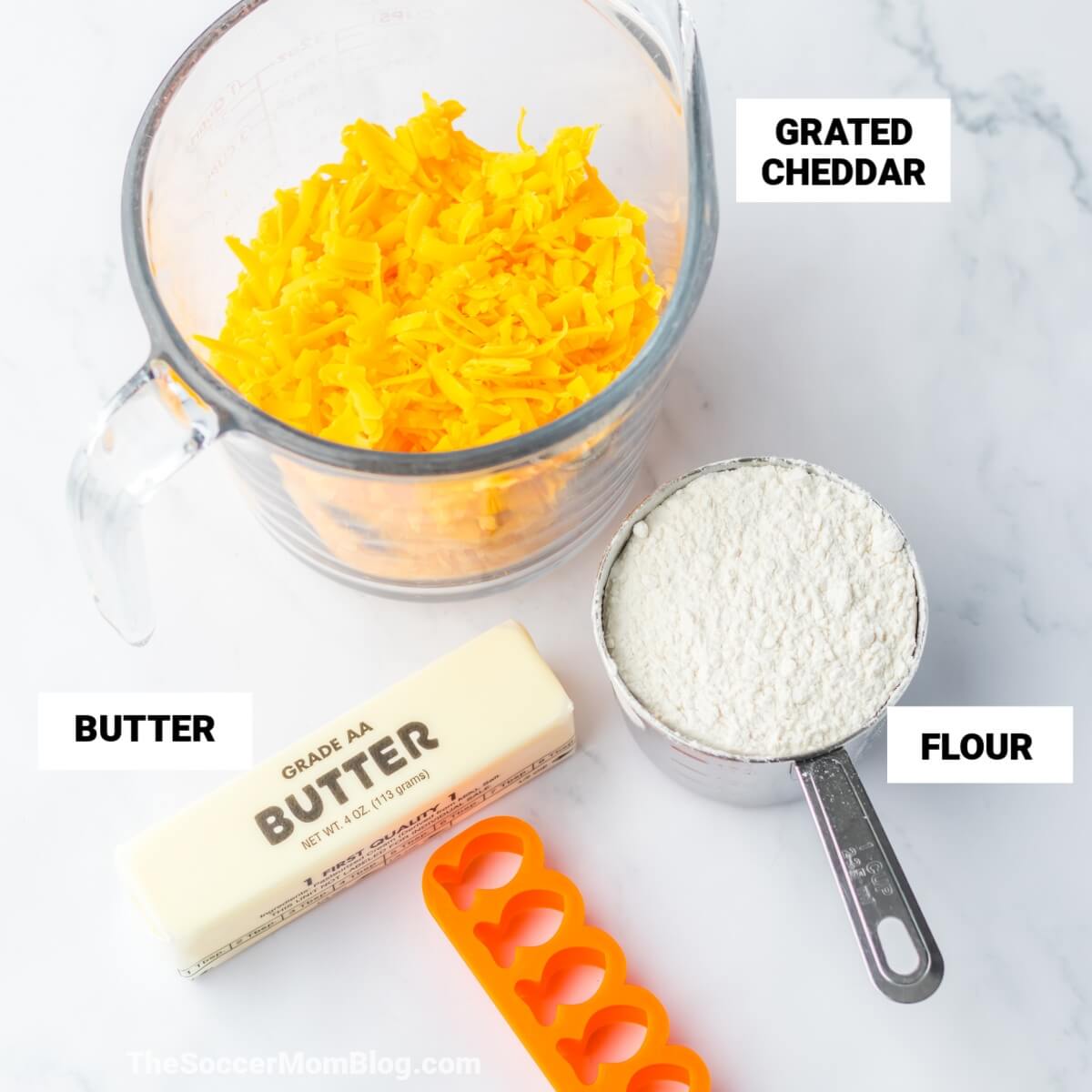 Homemade Goldfish Crackers Ingredients, with text labels: grated cheddar, flour, butter.