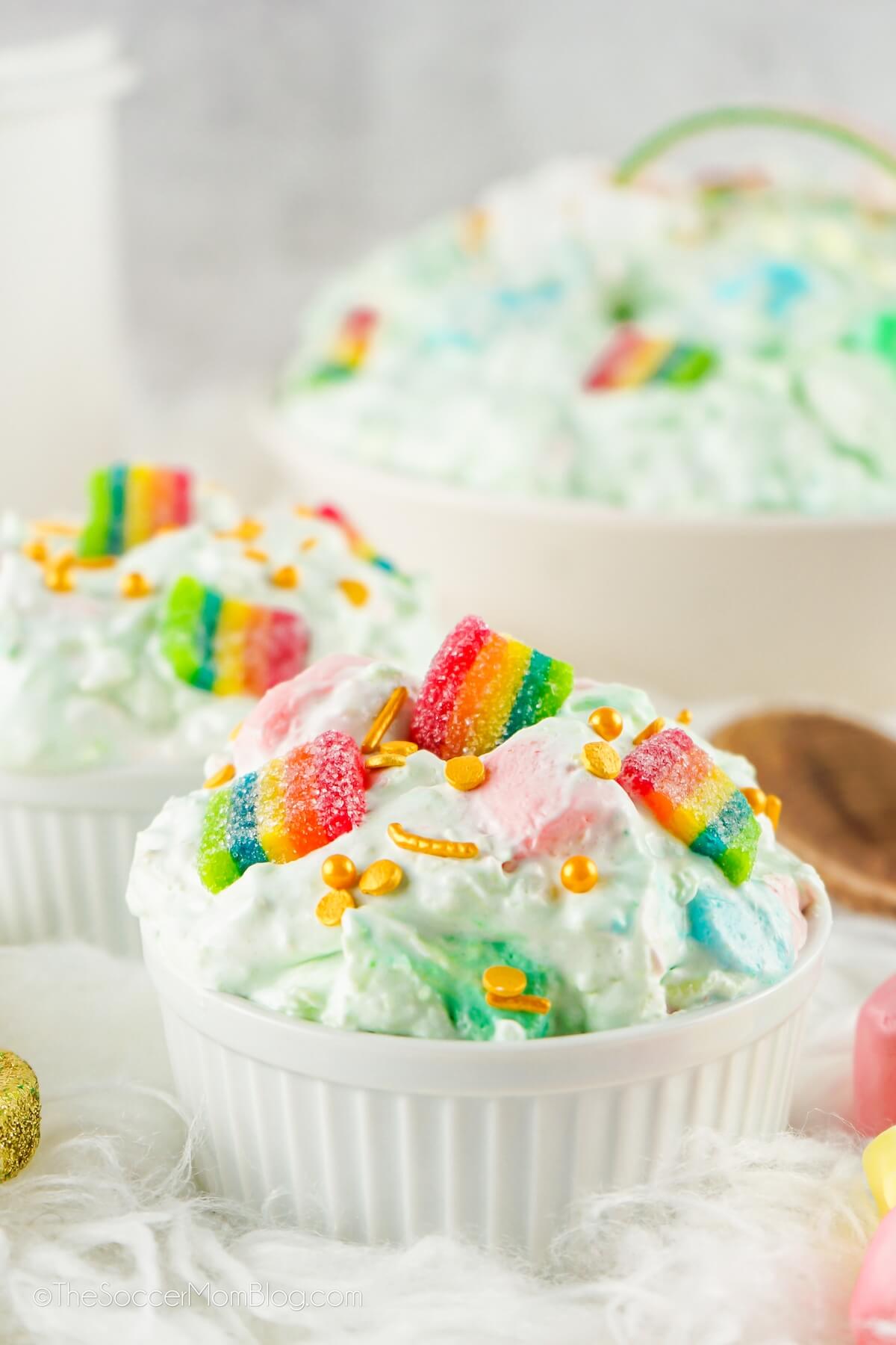 two bowls of green fluff salad with rainbow candy.