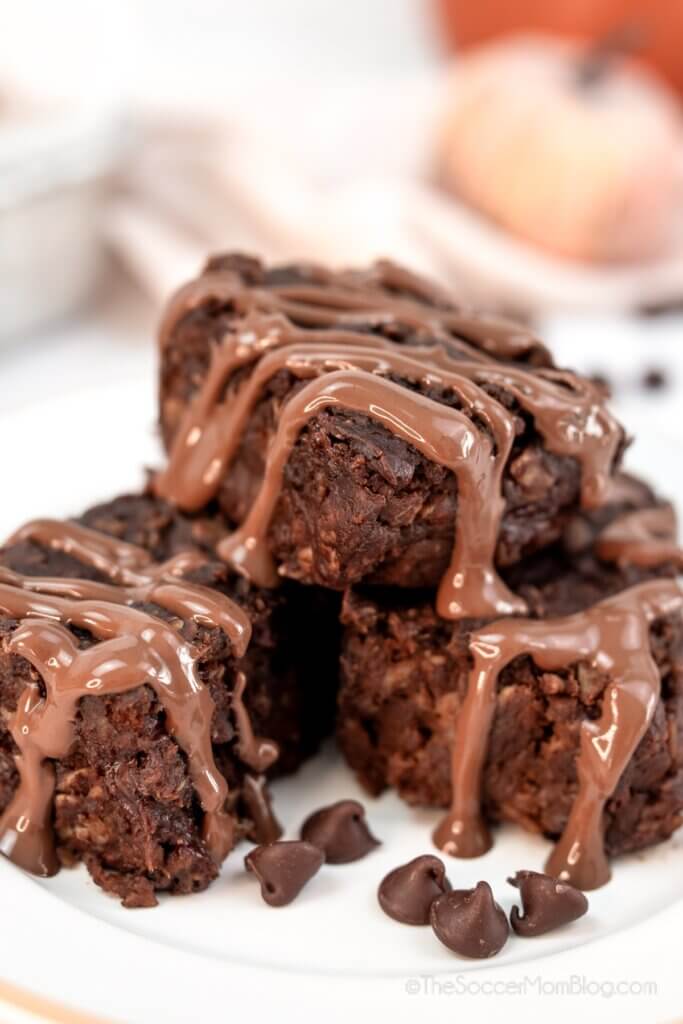 stack of healthy brownies topped with chocolate drizzle.