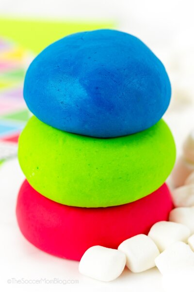 3 balls of colorful marshmallow playdough, with marshmallows in front.