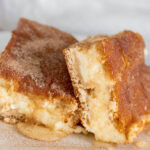 close up of two churro cheesecake squares.