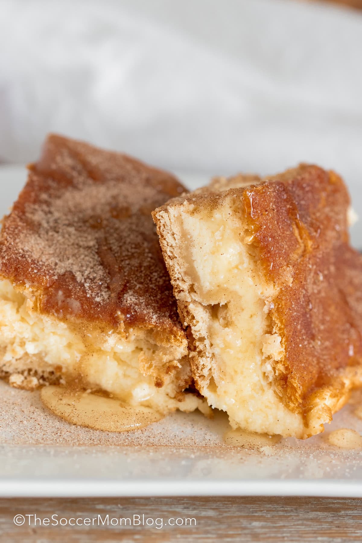 close up of two churro cheesecake squares.