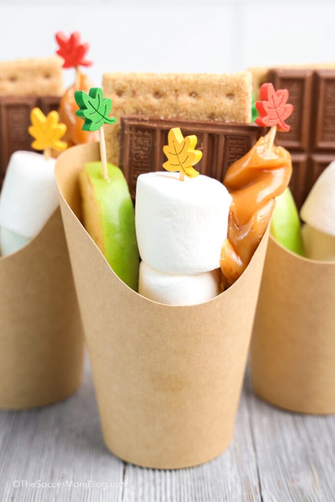 Caramel Apple S'mores Cups on a gray wooden table.