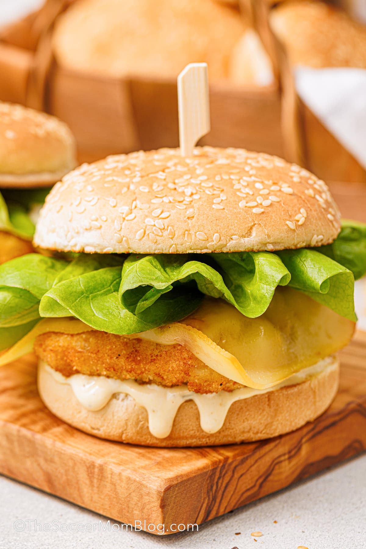 A Copycat Filet-O-Fish sandwich on a wooden tray.