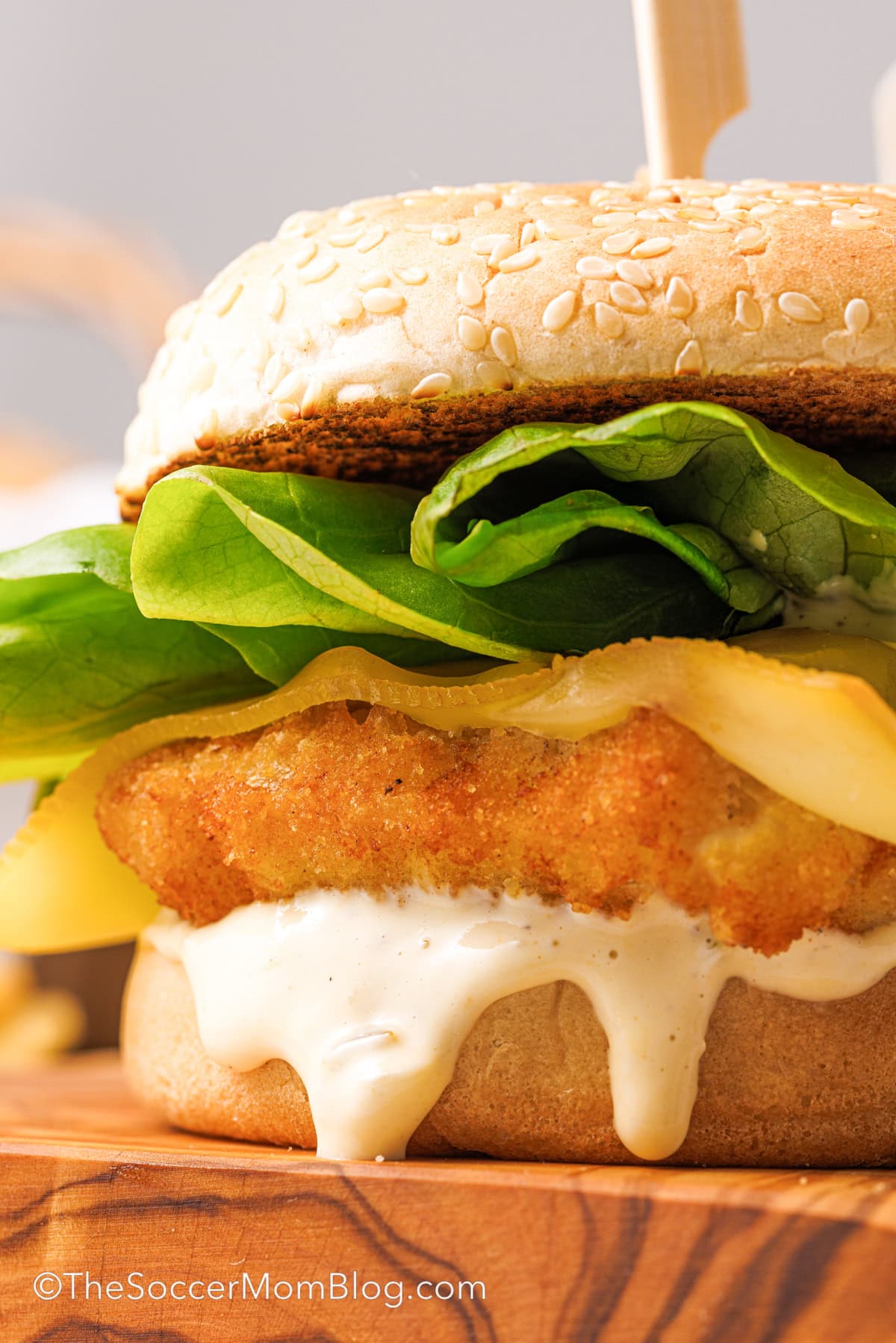 A Copycat Filet-O-Fish sandwich on a wooden tray.