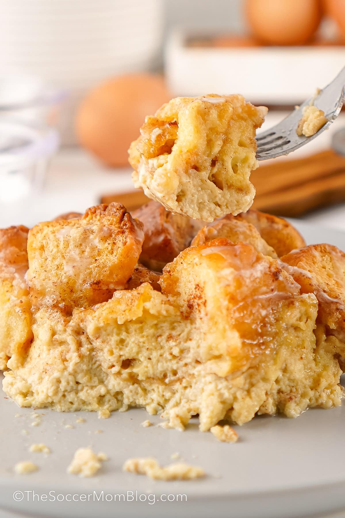 A forkful of Donut Bread Pudding being lifted off a plate.