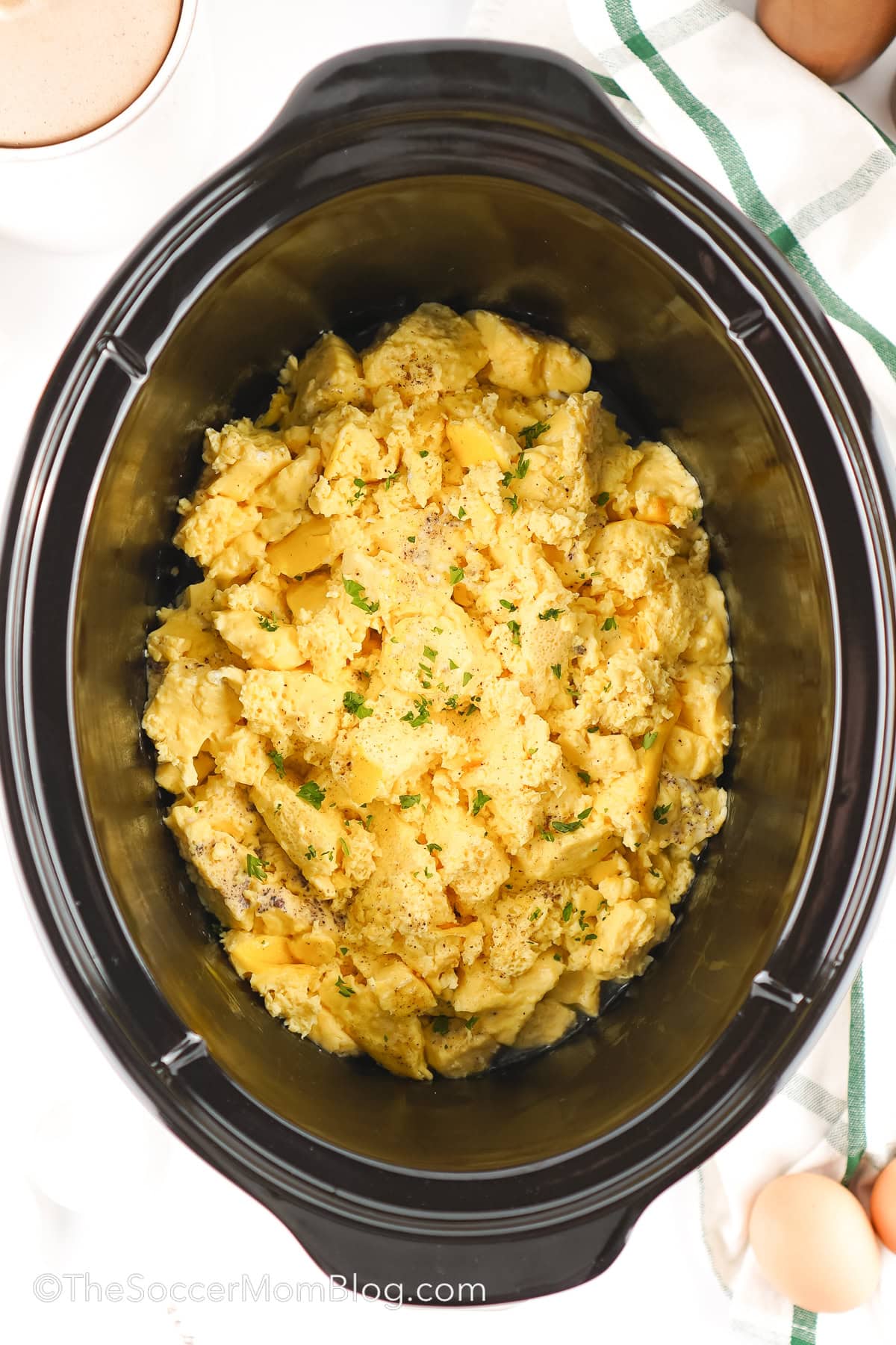 A crockpot full of scrambled eggs.