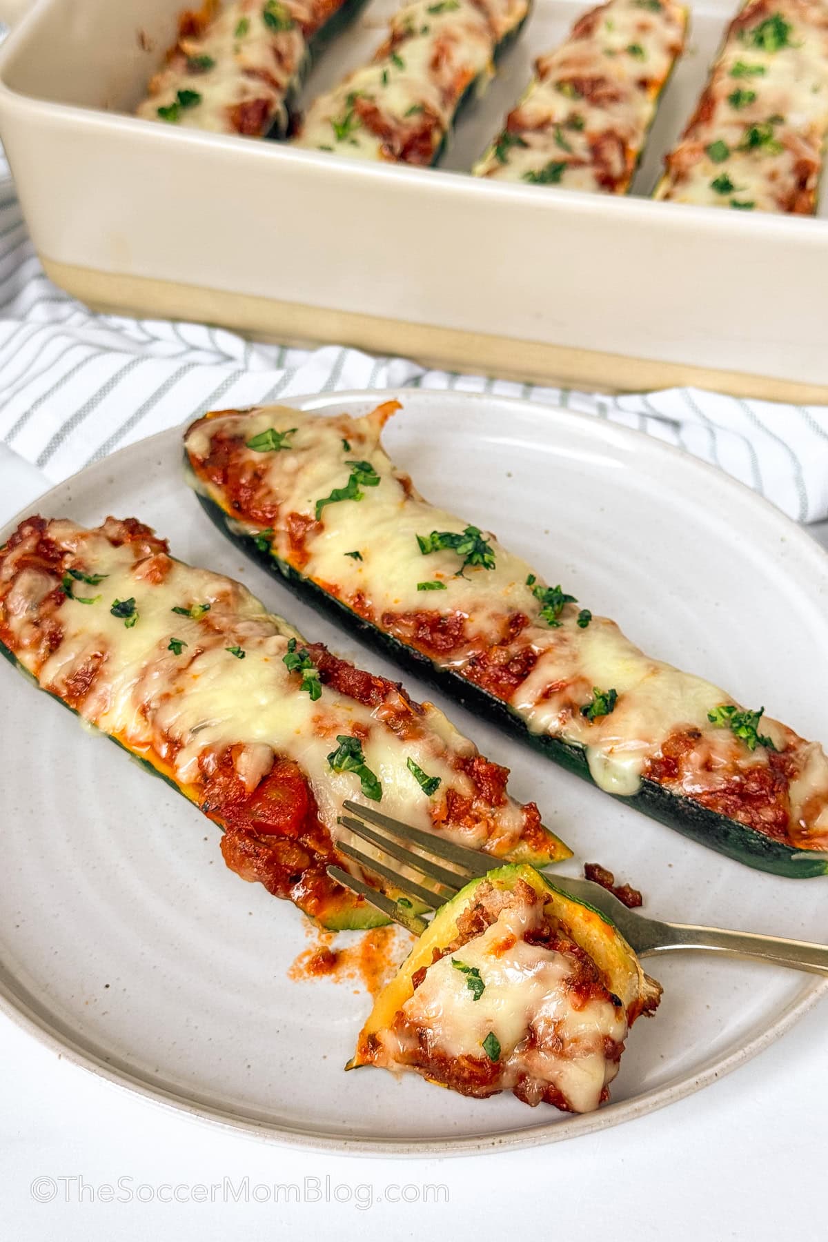 cutting into a stuffed zucchini.