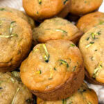 close up on a basket of homemade zucchini muffins.