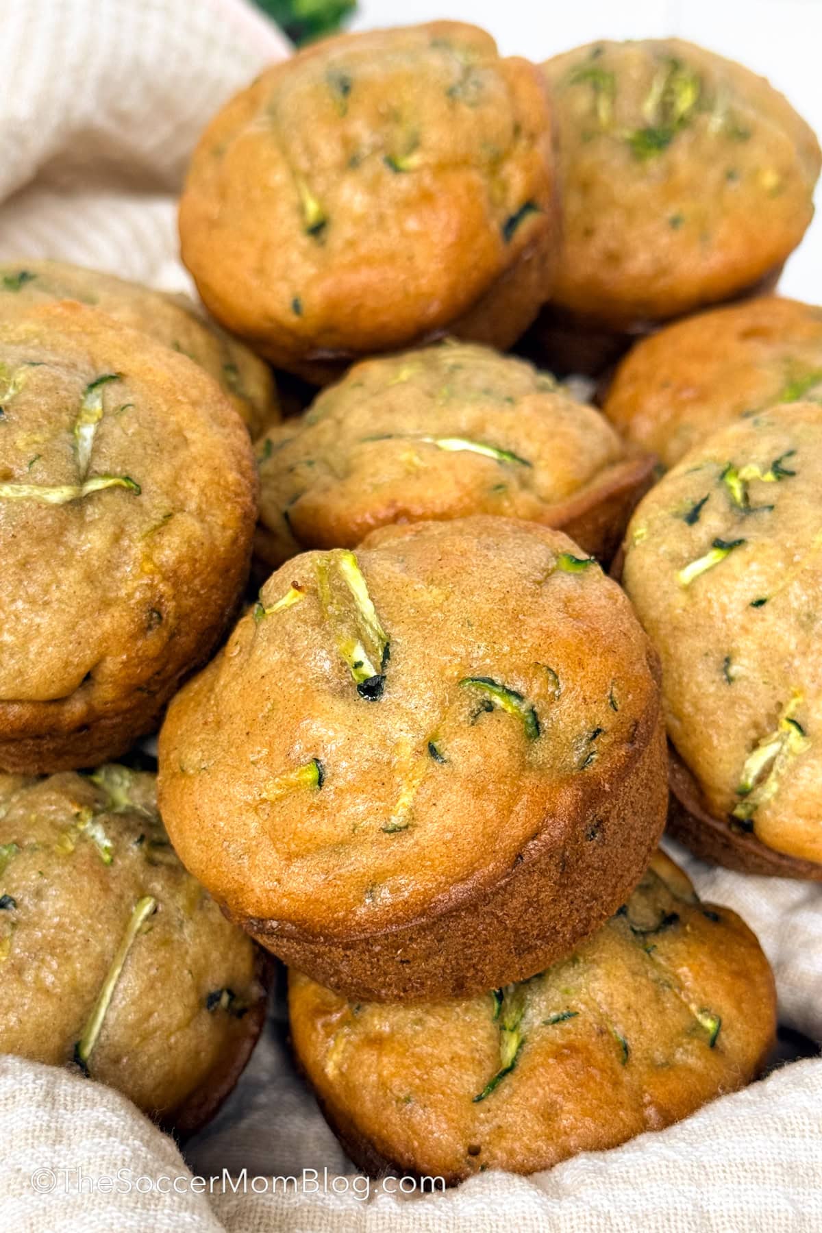 close up on a basket of homemade zucchini muffins.