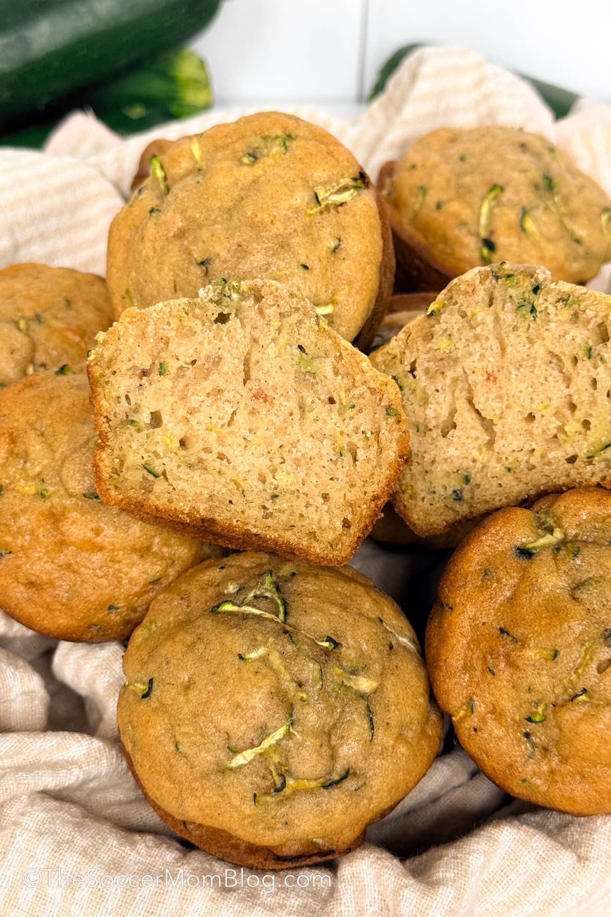zucchini muffins, with one cut in half.