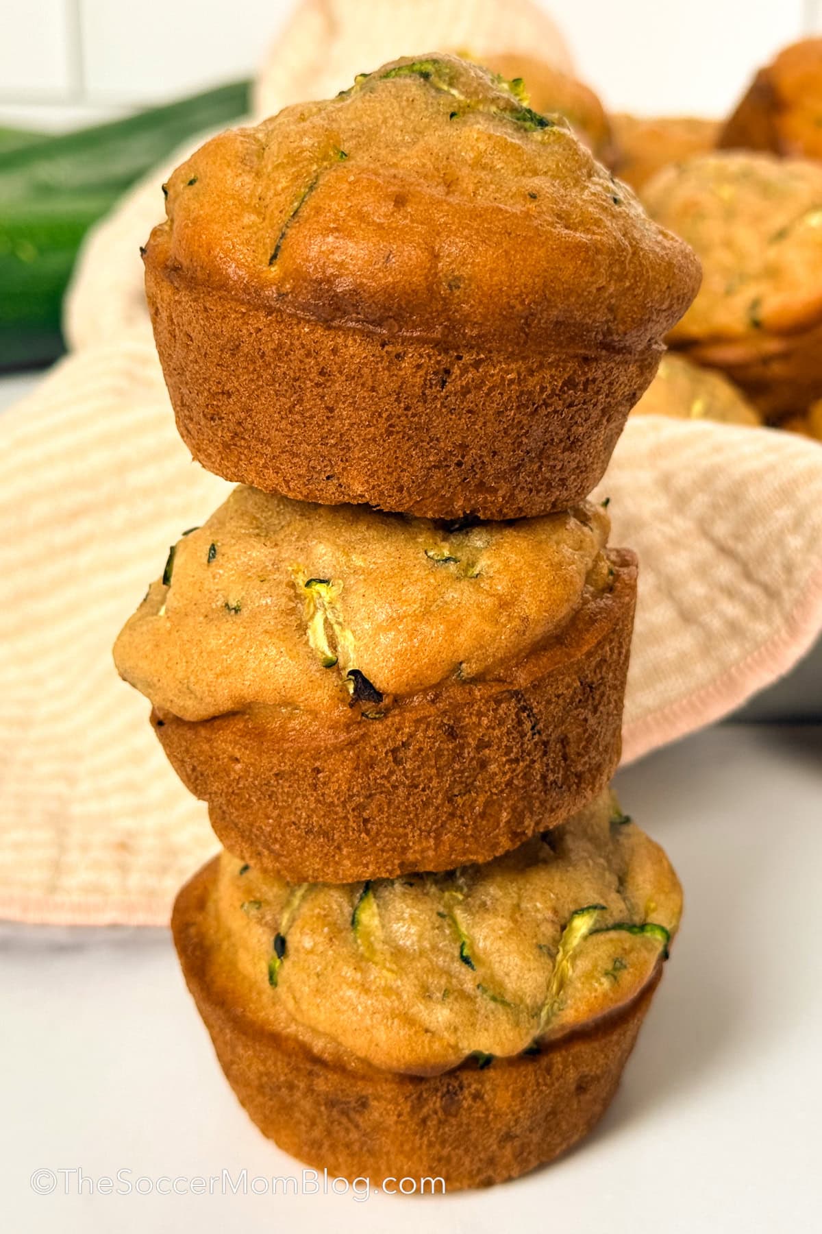 a stack of 3 zucchini muffins.