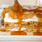 fork taking a bite of a layered apple pie icebox cake.