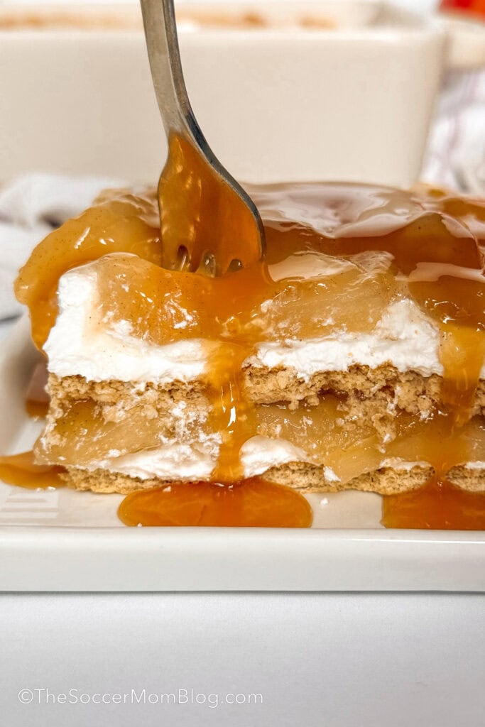 fork taking a bite of a layered apple pie icebox cake.