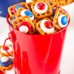 a red bucket of pretzel bites decorated in red, white, and blue candy.