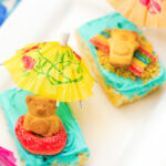 Two beach day rice krispie treats on a white plate.
