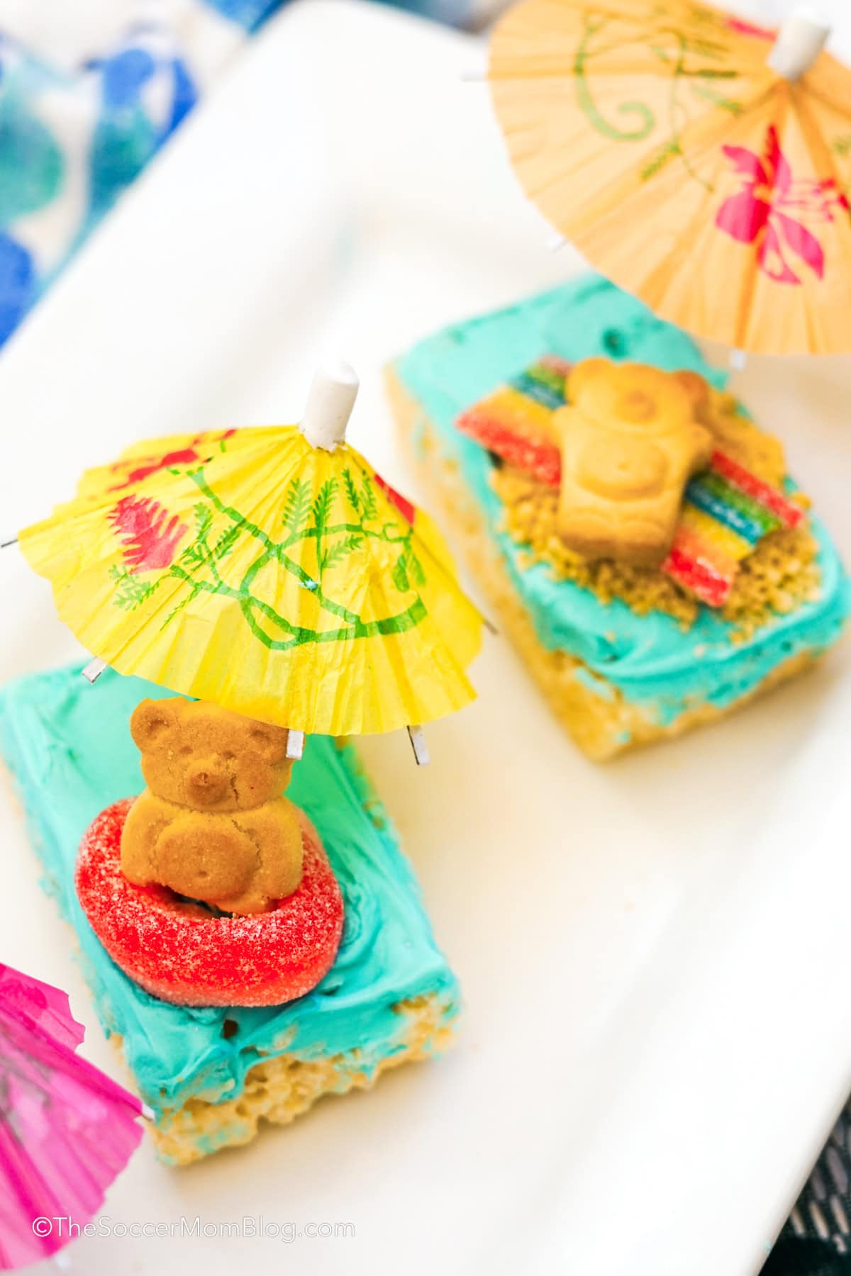 Two beach day rice krispie treats on a white plate.