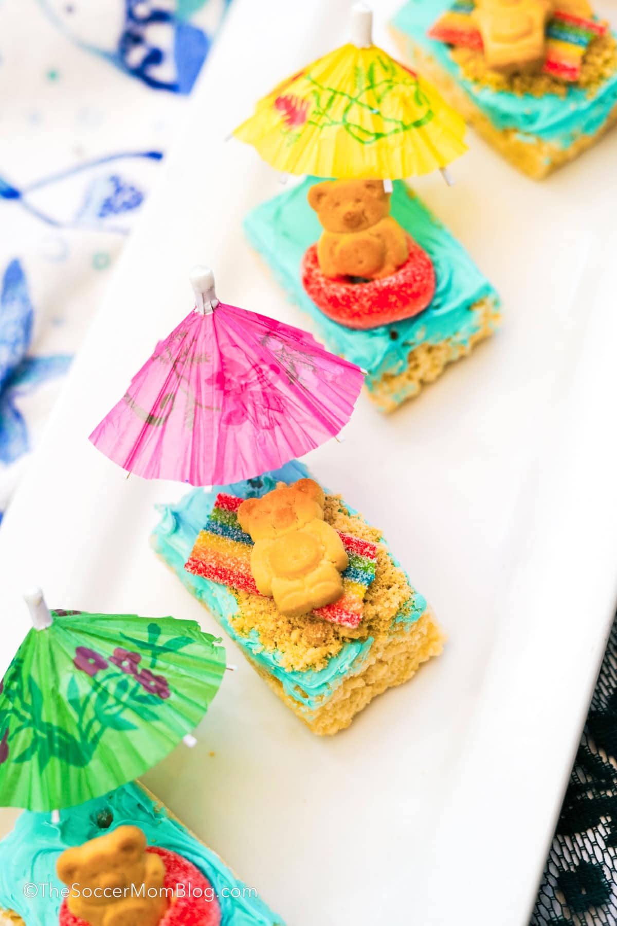 Pool party rice krispie treats lined up on a tray.