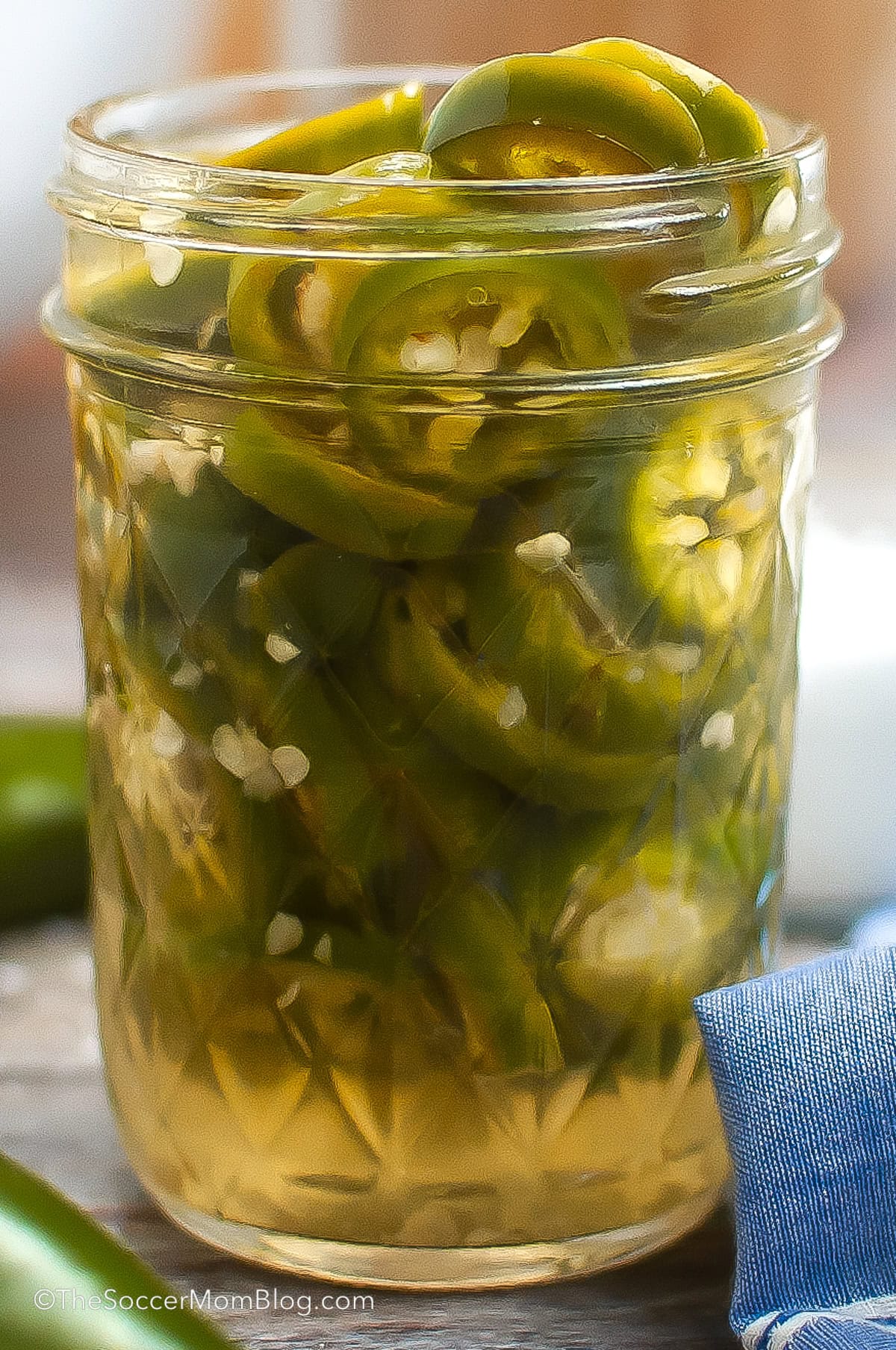 close up on a jar of homemade pickled jalapeños.