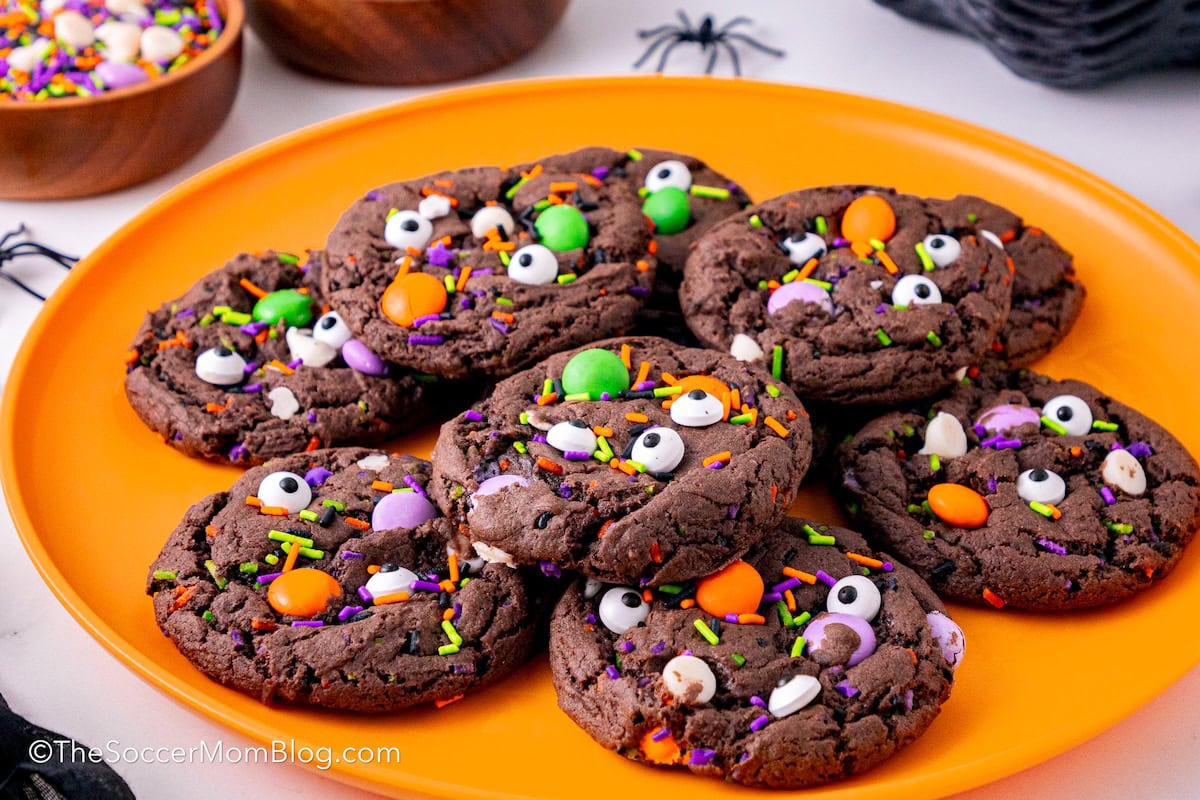 Chocolate Halloween Monster Cookies on an orange plate.