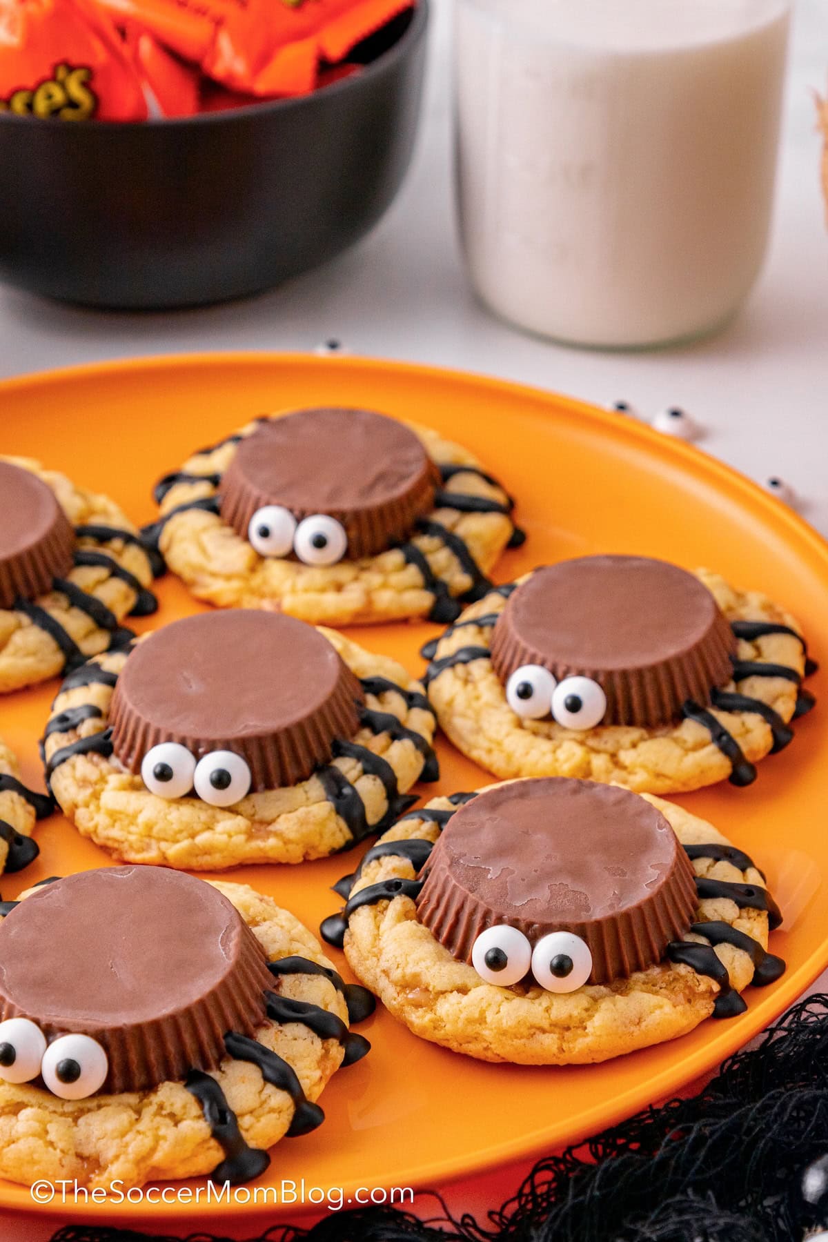 plate of Halloween spider cookies made with peanut butter cups and icing.