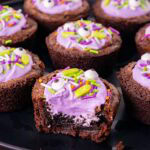 bite-size brownies filled with purple frosting and sprinkles to look like witch's cauldrons for Halloween/