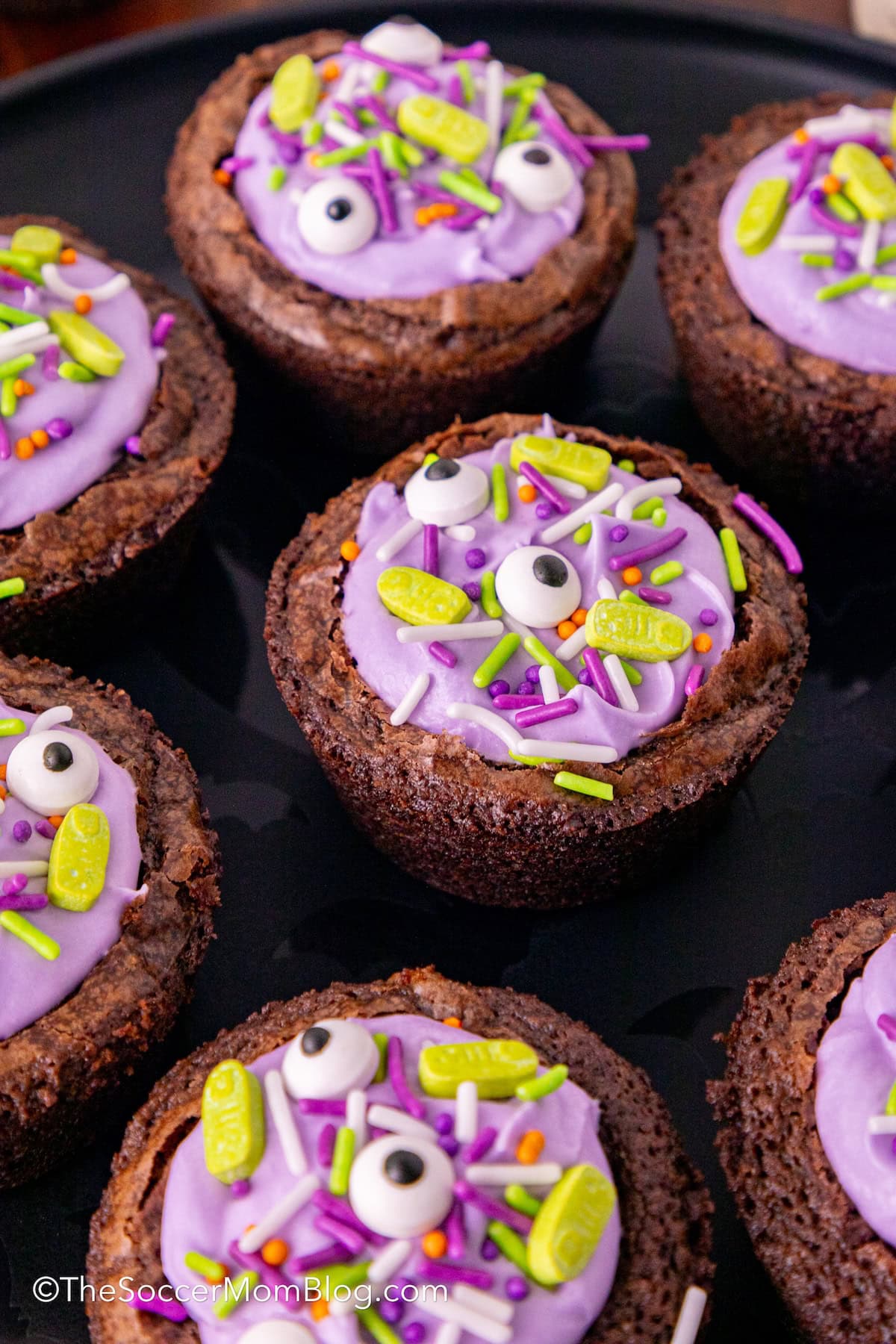 bite-size round brownies filled with purple frosting and Halloween sprinkles.