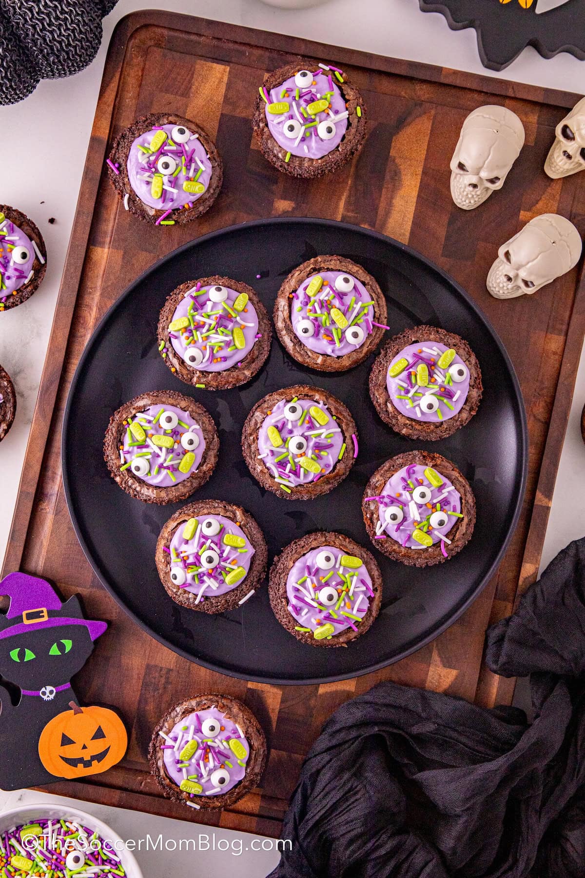 a platter of witches cauldron brownies surrounded by Halloween decor.