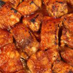 cooked barbecue salmon pieces on a baking sheet